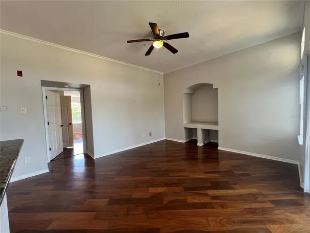a view of a kitchen with a sink and wooden floor