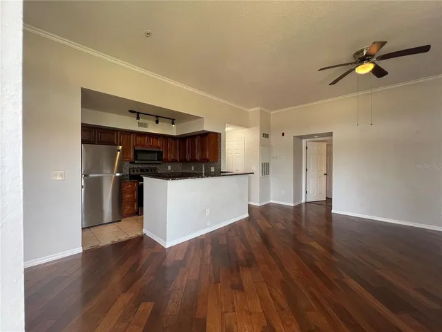 a kitchen with stainless steel appliances a refrigerator and a stove top oven