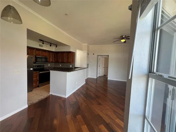 a kitchen with granite countertop a refrigerator and a stove top oven