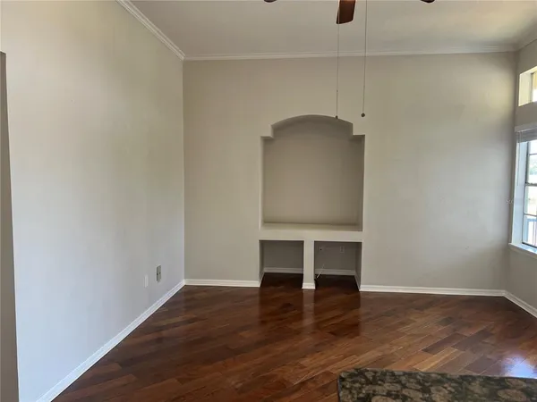 wooden floor in an empty room with a window