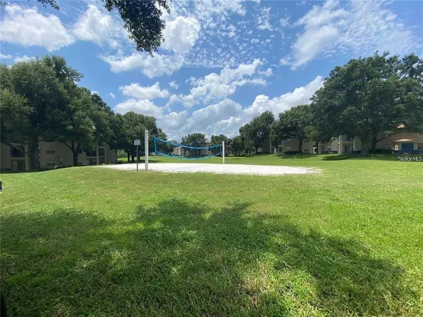 a swimming pool with outdoor seating and yard