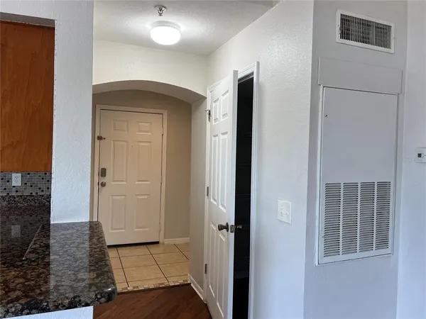 a view of a livingroom with wooden floor and cabinet