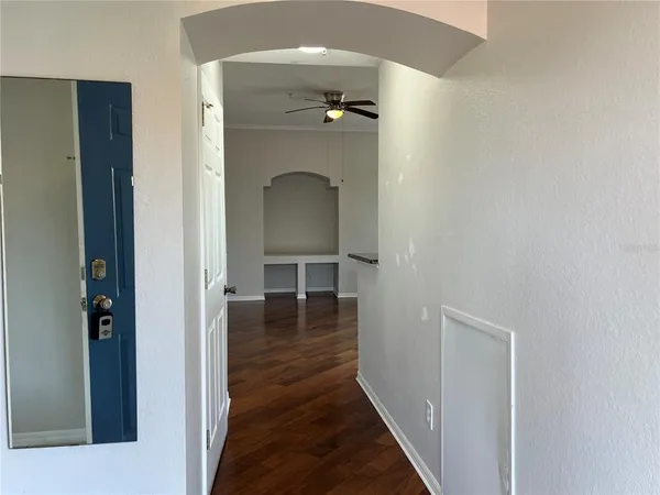 a view of a hallway view with wooden floor and staircase