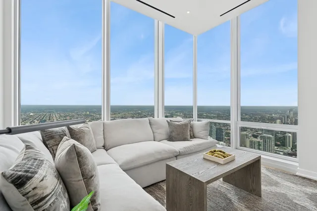 a living room with furniture and a floor to ceiling window
