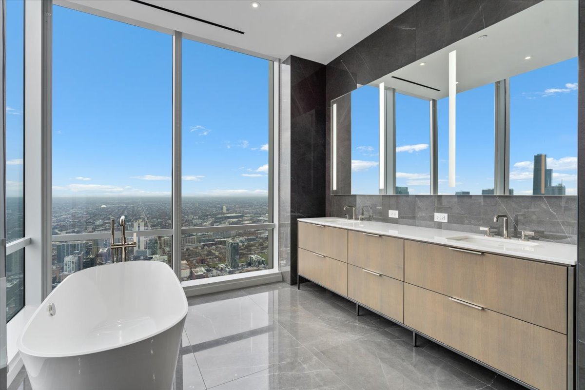 14 West Superior Street, Unit 6002 Chicago, IL 60654 - Photo 22 of 44 a bathroom with a double vanity sink and a large mirror