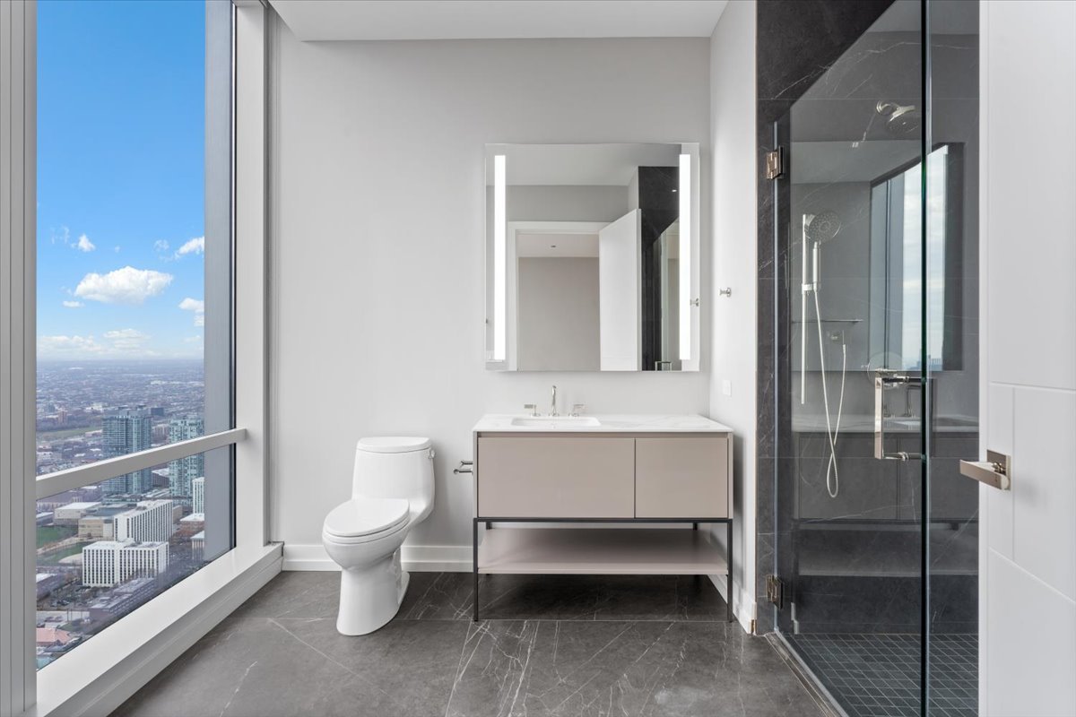 14 West Superior Street, Unit 6002 Chicago, IL 60654 - Photo 27 of 44 a bathroom with a toilet sink and shower