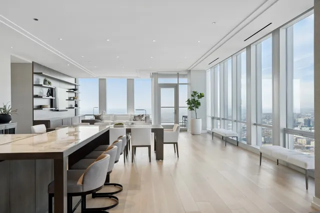 a view of a a dining room with furniture window and wooden floor