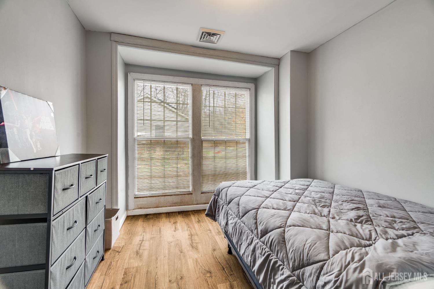 113 Fresh Ponds Road Monroe Township, NJ 08831 - Photo 11 of 18 a bedroom with a bed and a flat tv screen on a dresser