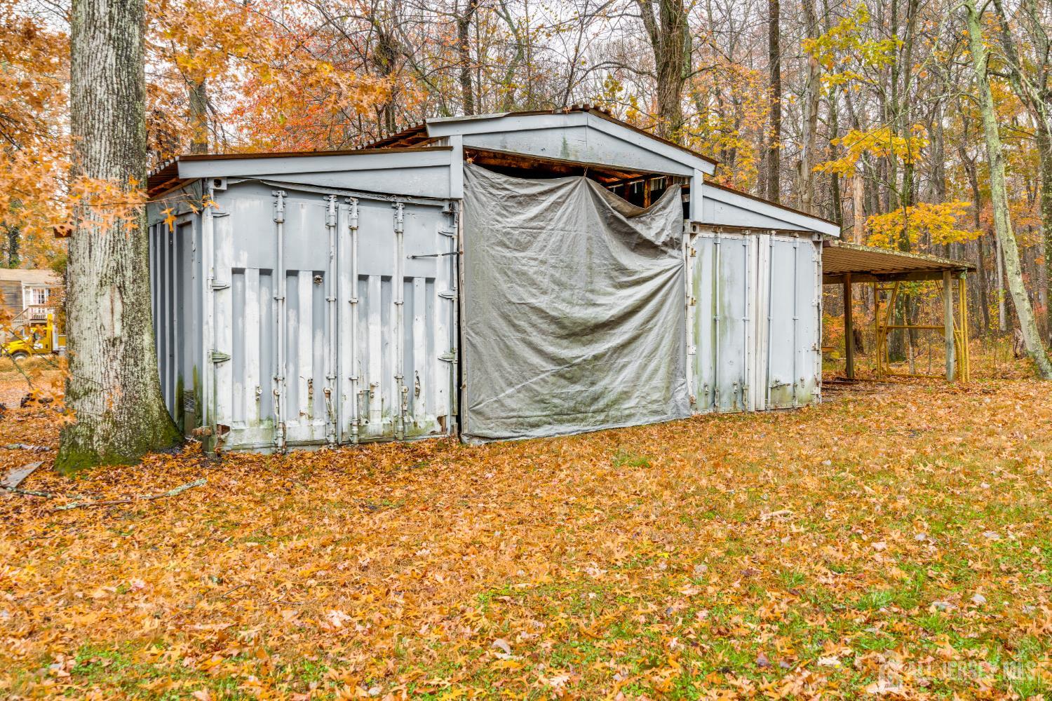 113 Fresh Ponds Road Monroe Township, NJ 08831 - Photo 16 of 18 a side view of a house with a wall
