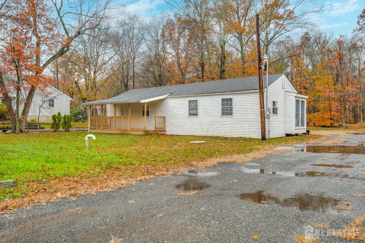 113 Fresh Ponds Road Monroe Township, NJ 08831 - Photo 18 of 18 a view of a yard in front of a house with large trees