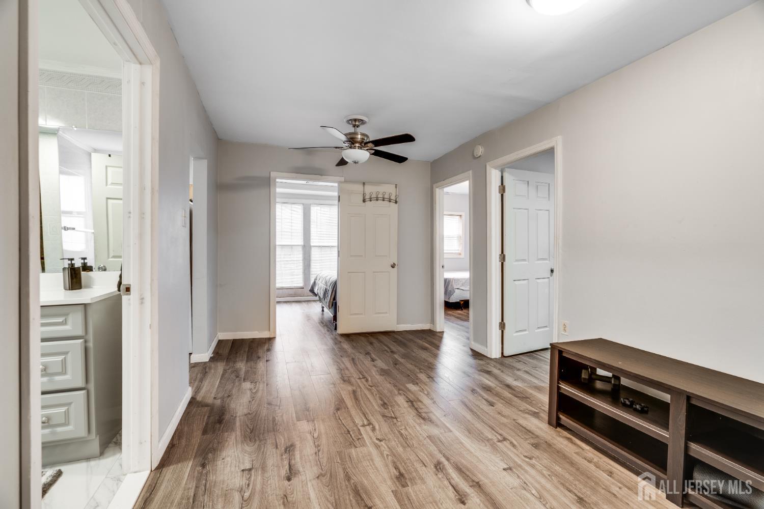 113 Fresh Ponds Road Monroe Township, NJ 08831 - Photo 6 of 18 wooden floor in an empty room with a window