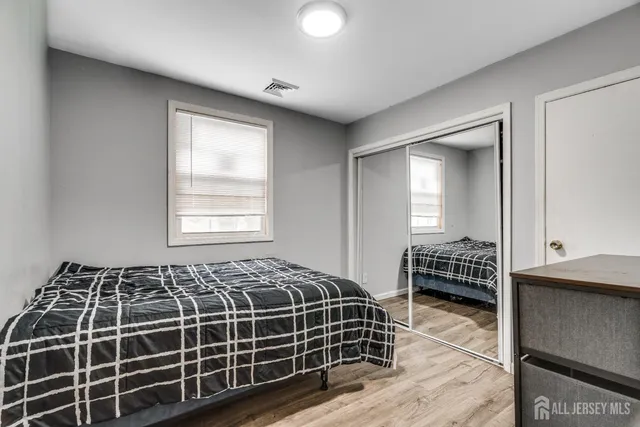 a bedroom with bed and window