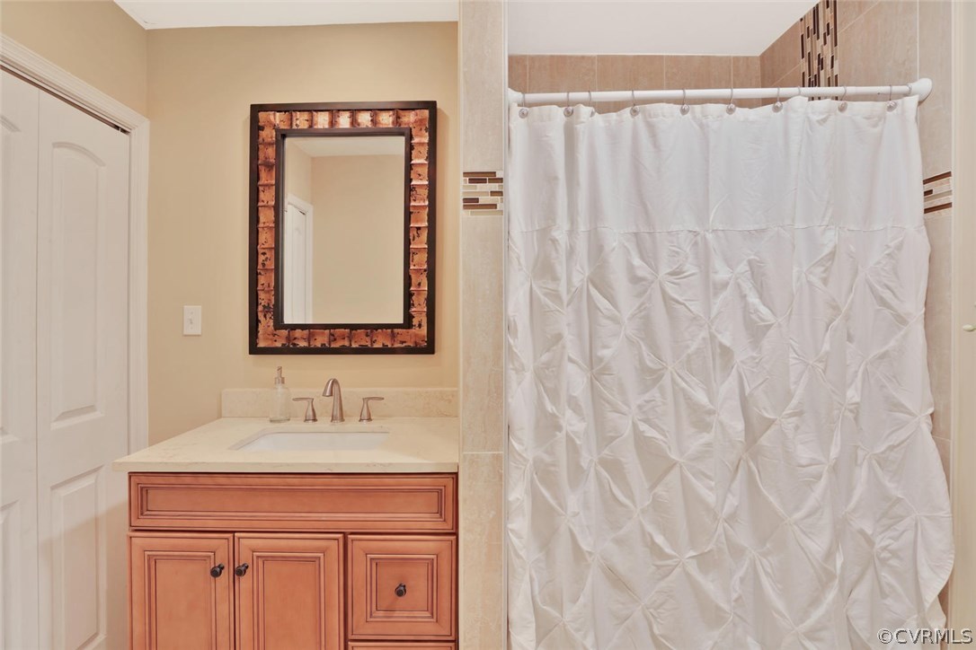 21003 Skinquarter Road Moseley, VA 23120 - Photo 14 of 22 a bathroom with a sink vanity and a mirror