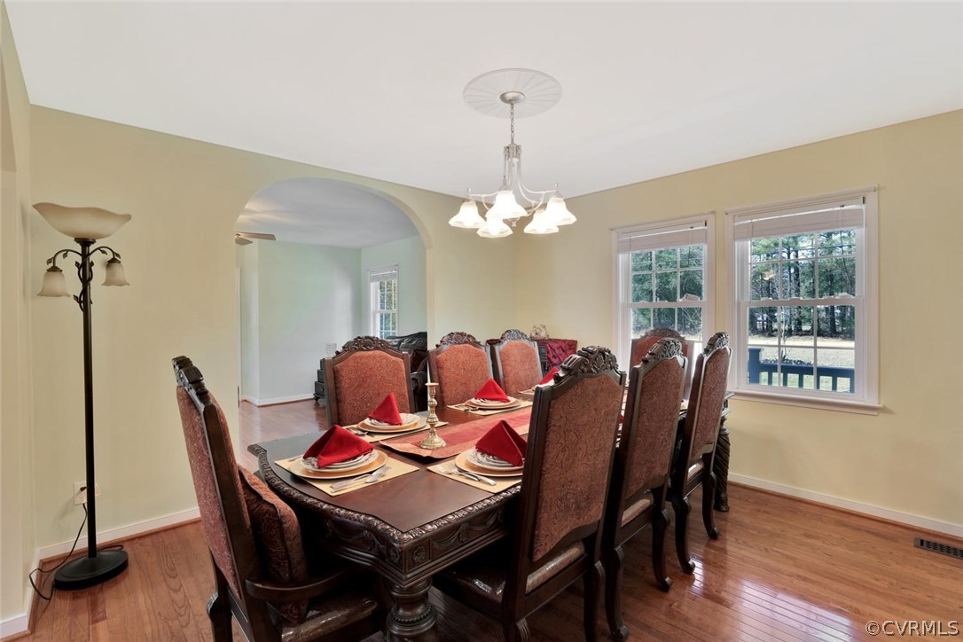21003 Skinquarter Road Moseley, VA 23120 - Photo 3 of 22 a view of a dining room with furniture window and wooden floor