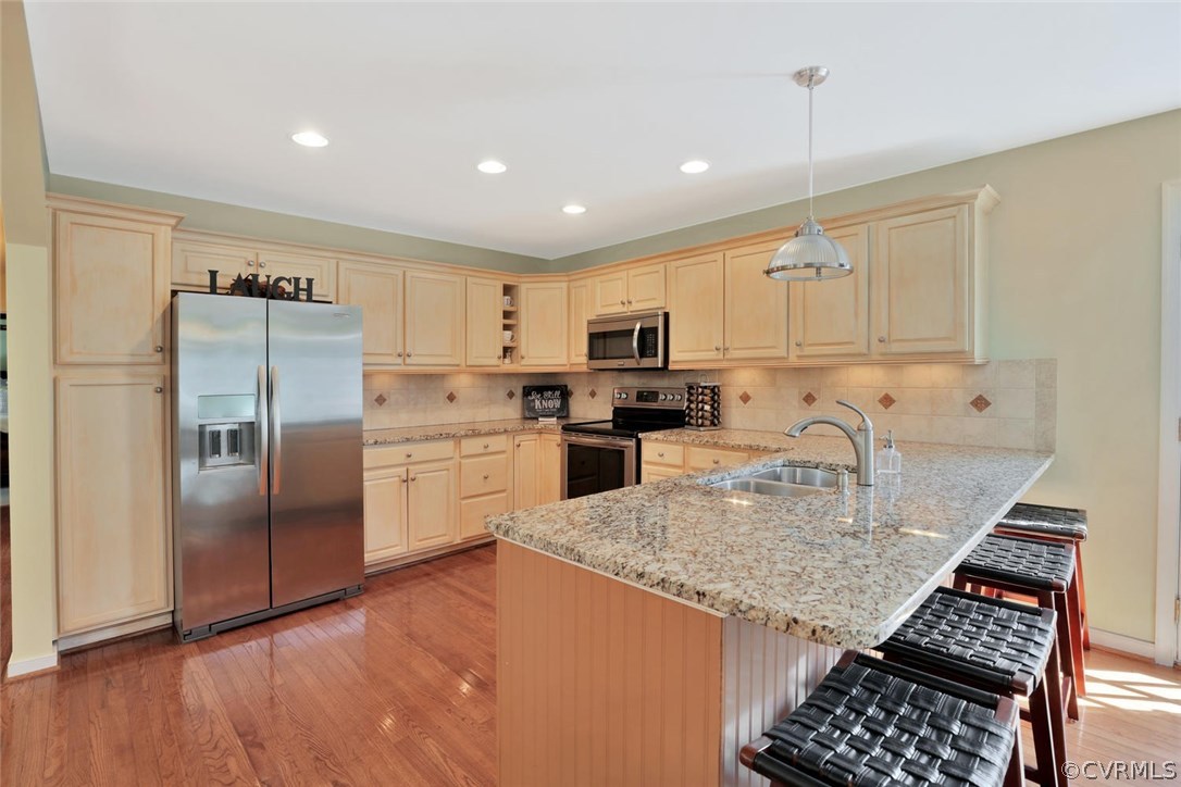 21003 Skinquarter Road Moseley, VA 23120 - Photo 5 of 22 a kitchen with granite countertop kitchen island stainless steel appliances a refrigerator a stove a sink and a center island