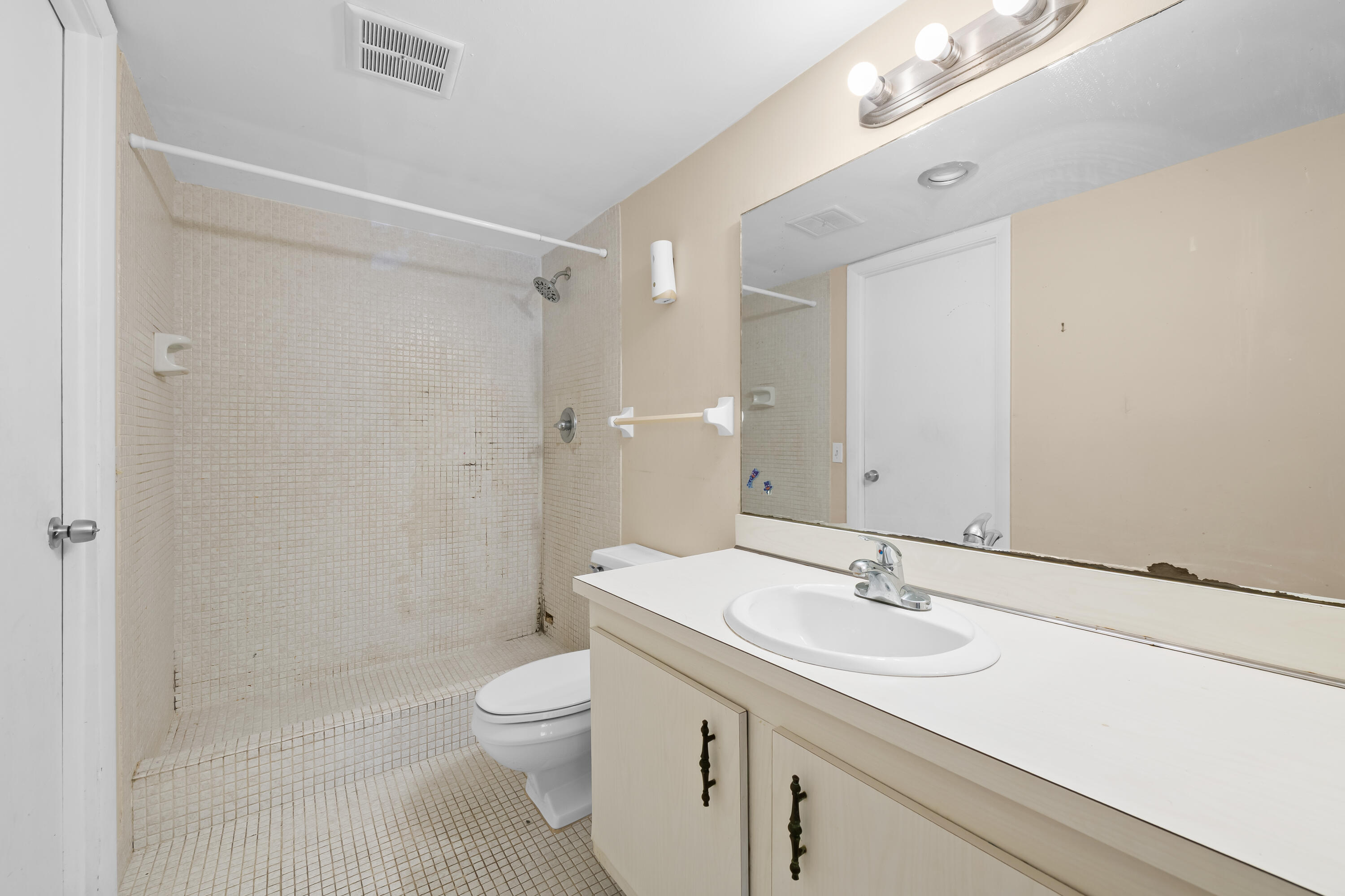 4156 Inverrary Drive, Unit 210 Lauderhill, FL 33319 - Photo 5 of 27 a bathroom with a sink a toilet and shower