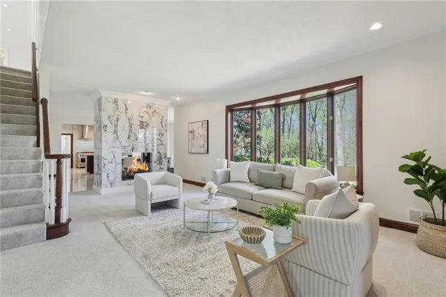 a living room with furniture and large windows