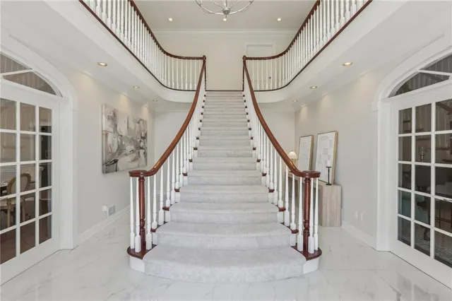 a view of staircase with white walls and a window
