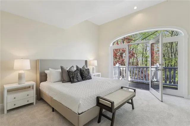 a bedroom with a bed and a large window