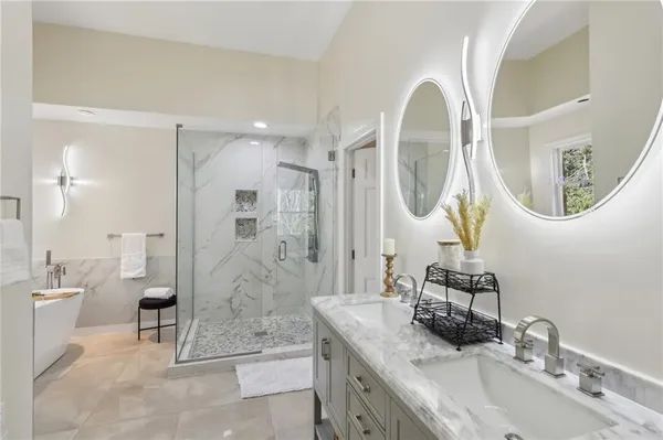 a bathroom with a granite countertop sink mirror and shower