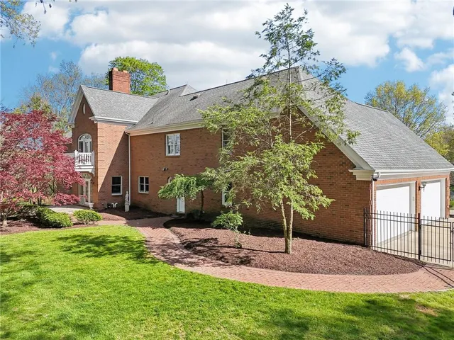 a front view of a house with a garden and yard