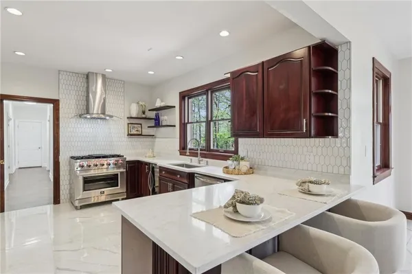 a kitchen with a sink stove and wooden floor