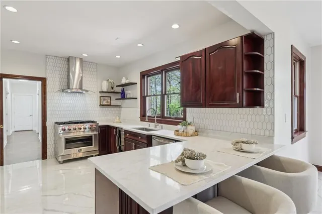 a kitchen with a sink stove and wooden floor
