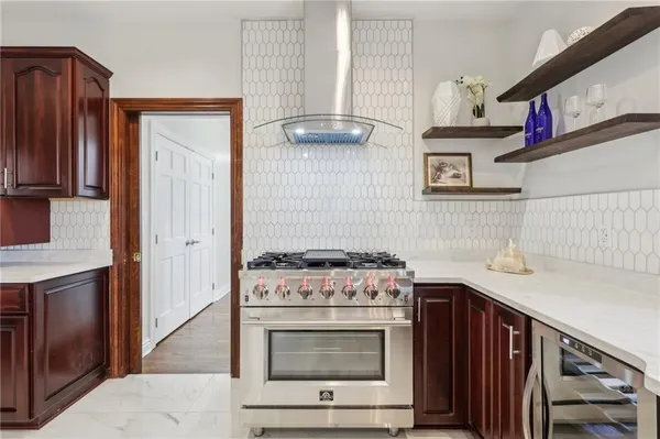 a kitchen with stainless steel appliances granite countertop a stove and a microwave
