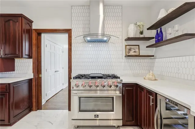 a kitchen with stainless steel appliances granite countertop a stove and a microwave