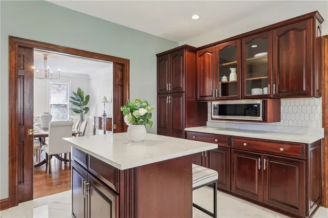 a kitchen with a stove microwave and dining table