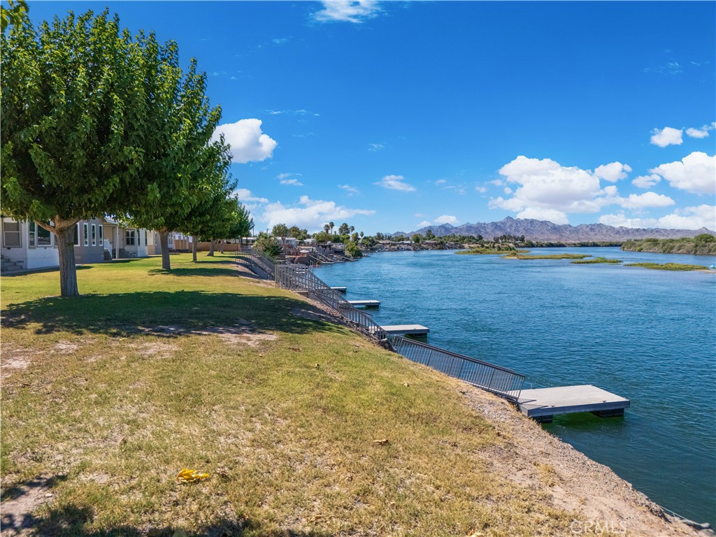 5900 Colorado River Road, Unit 18 Blythe, CA 92225 - Photo 57 of 58 a view of a lake with houses in the back