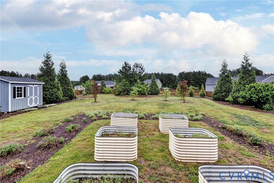 8904 Rock Cedar Road New Kent, VA 23124 - Photo 25 of 37 a view of a patio with table and chairs and potted plants