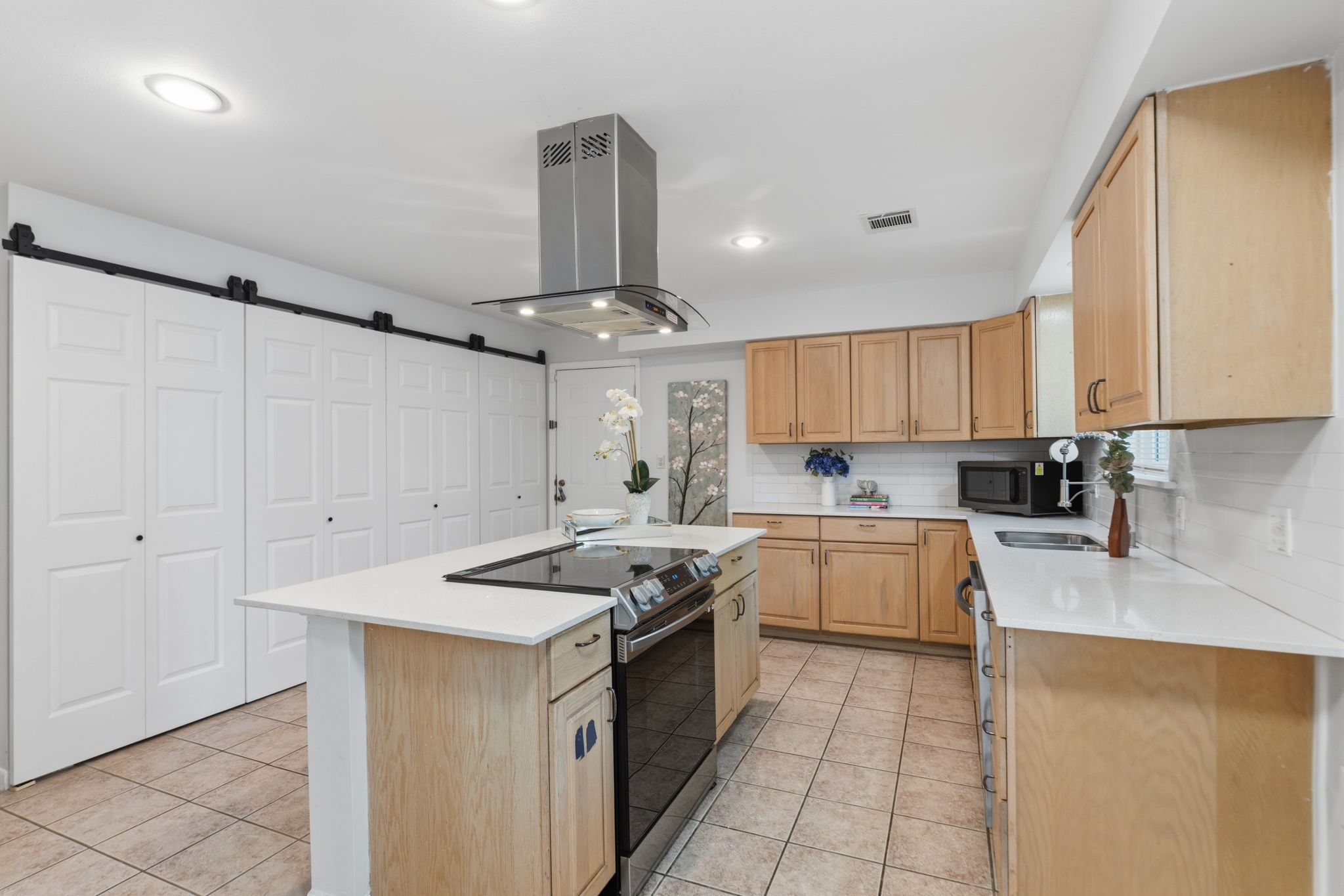 5410 Indigo Street Houston, TX 77096 - Photo 11 of 30 The kitchen features an expanded pantry for extra storage, sleek countertops, a Chef's Island and tons of cabinets.