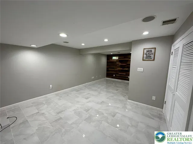 a bathroom with a toilet and a mirror