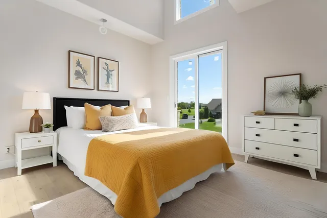 a bedroom with a bed and painting on the wall