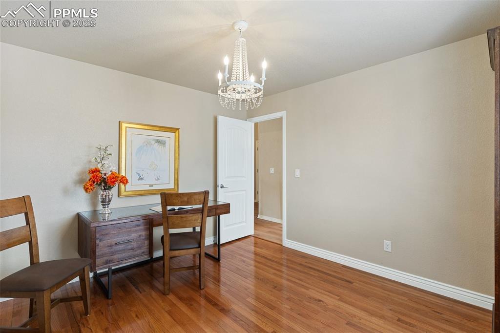 977 Salmon Pond Way Colorado Springs, CO 80921 - Photo 12 of 49 a view of a dining room with furniture and wooden floor