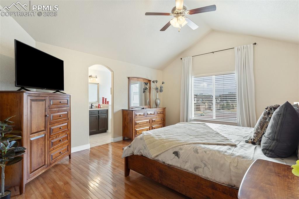 977 Salmon Pond Way Colorado Springs, CO 80921 - Photo 14 of 49 a spacious bedroom with a bed and a flat screen tv