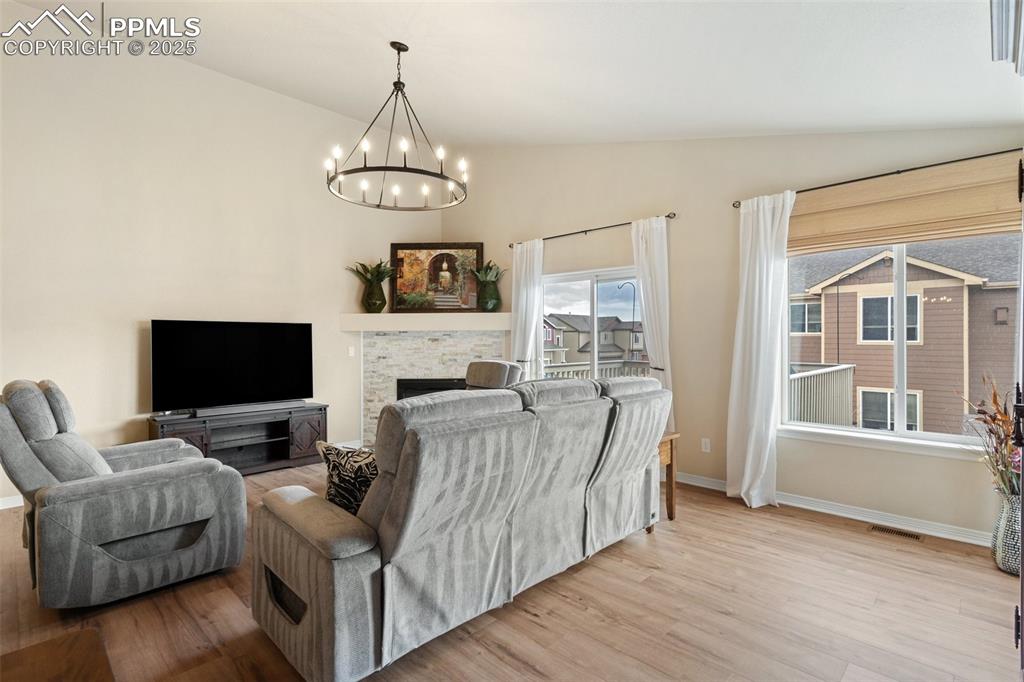 977 Salmon Pond Way Colorado Springs, CO 80921 - Photo 20 of 49 a living room with furniture a flat screen tv and a fireplace