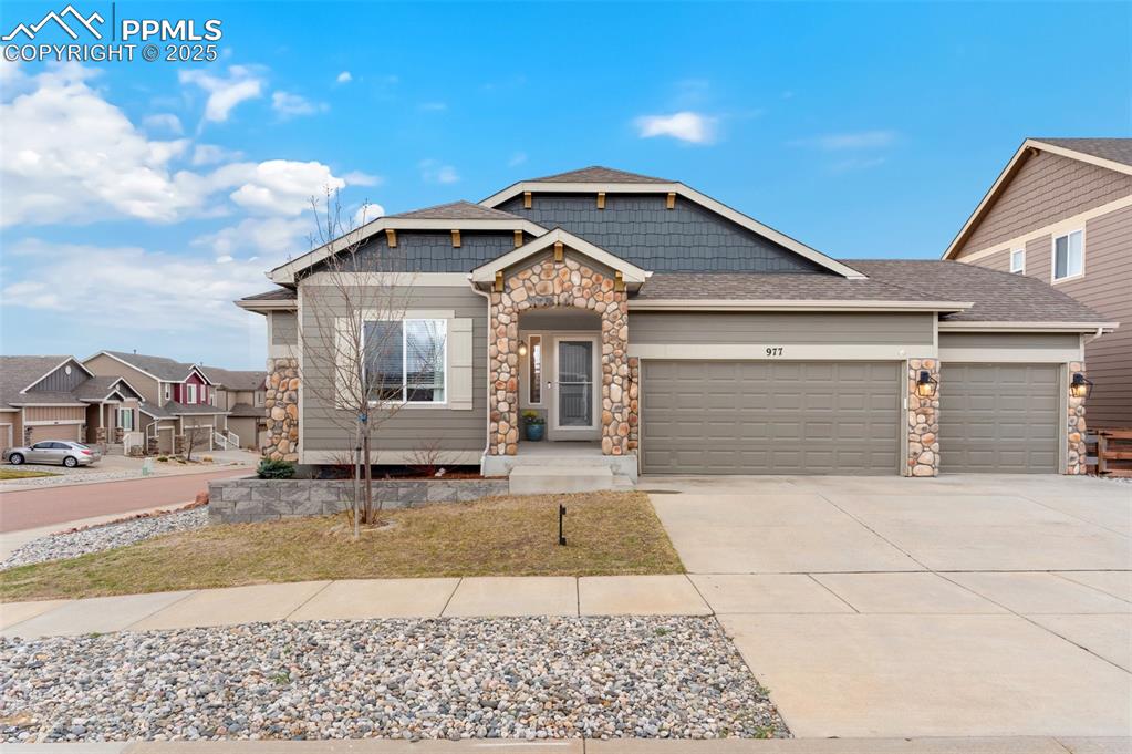 977 Salmon Pond Way Colorado Springs, CO 80921 - Photo 2 of 49 a front view of a house with a yard and garage