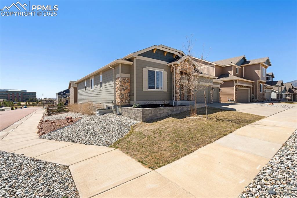 977 Salmon Pond Way Colorado Springs, CO 80921 - Photo 3 of 49 a front view of a house with a yard
