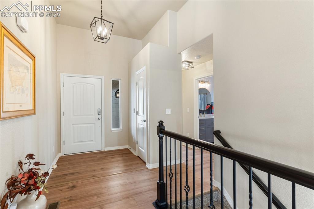 977 Salmon Pond Way Colorado Springs, CO 80921 - Photo 6 of 49 a view of a hallway view with wooden floor and staircase