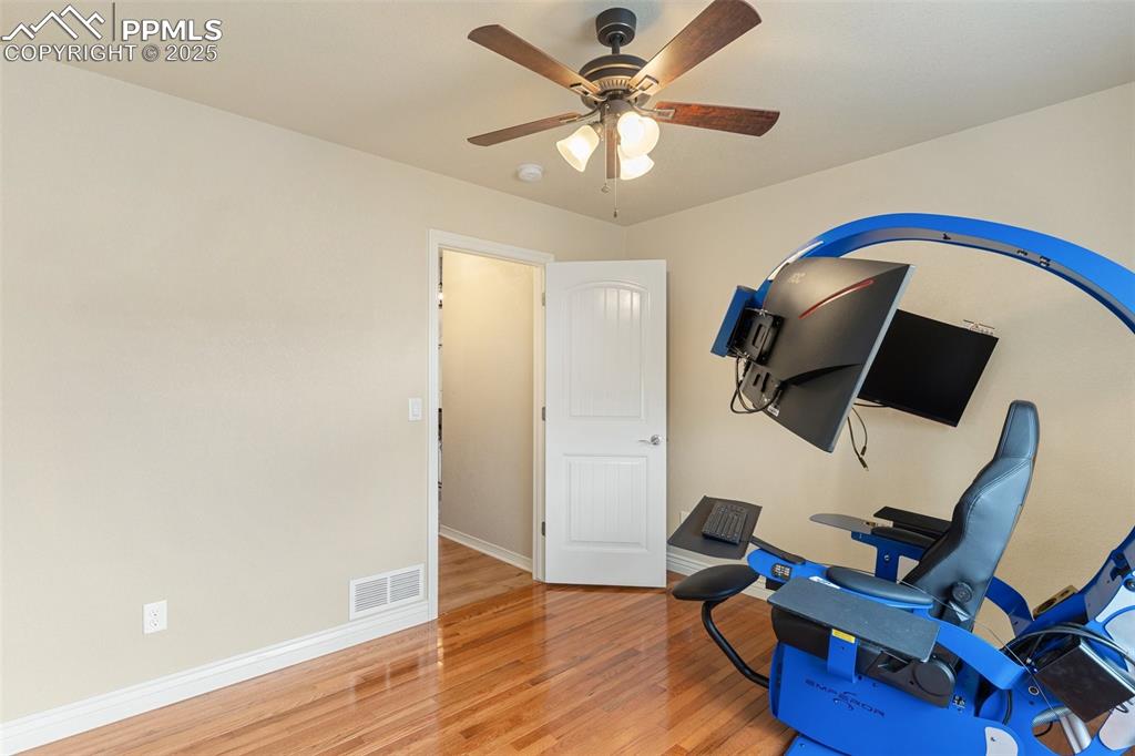 977 Salmon Pond Way Colorado Springs, CO 80921 - Photo 9 of 49 a view of workspace with wooden floor and ceiling fan