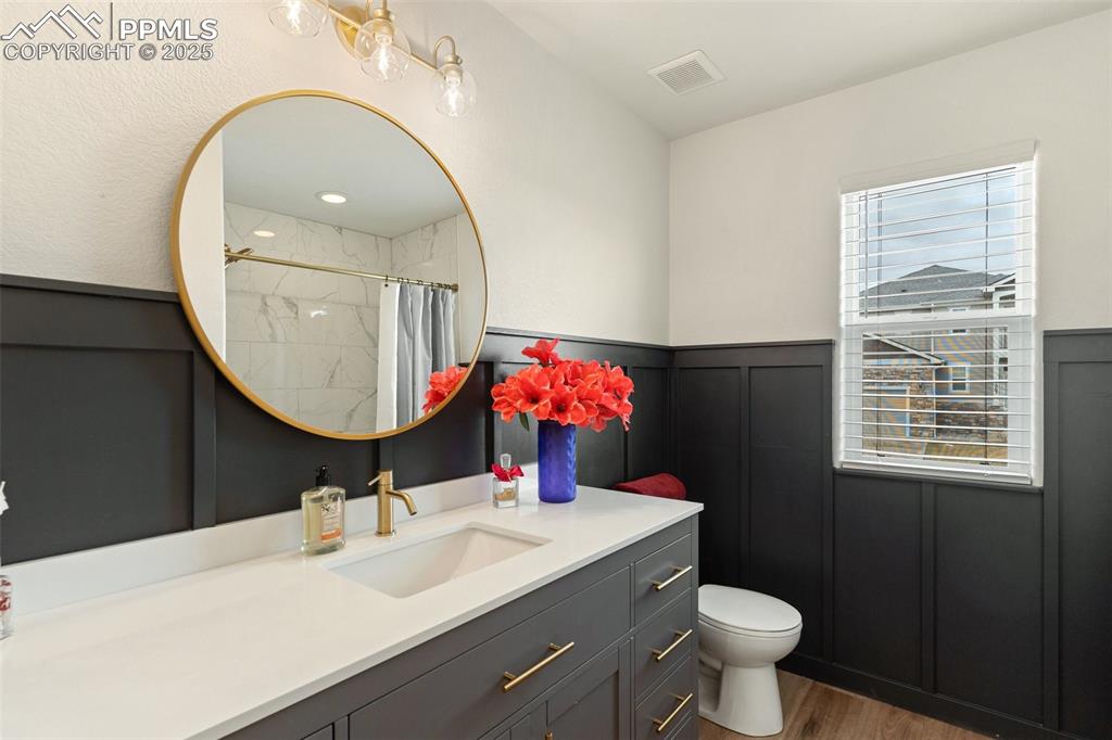 977 Salmon Pond Way Colorado Springs, CO 80921 - Photo 10 of 49 a bathroom with a sink mirror and toilet