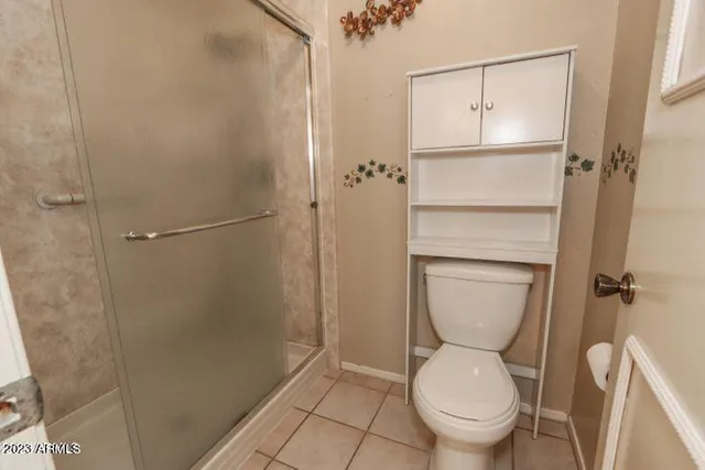 a view of a chair and tables in the patio with a small garden