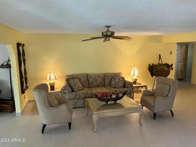 a view of a patio with table and chairs potted plants with sky view