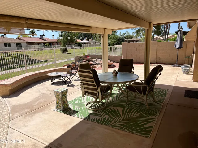 a roof deck with a table and chairs