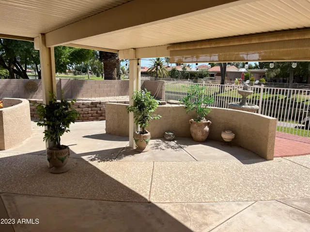 a view of a dining room with furniture and a chandelier