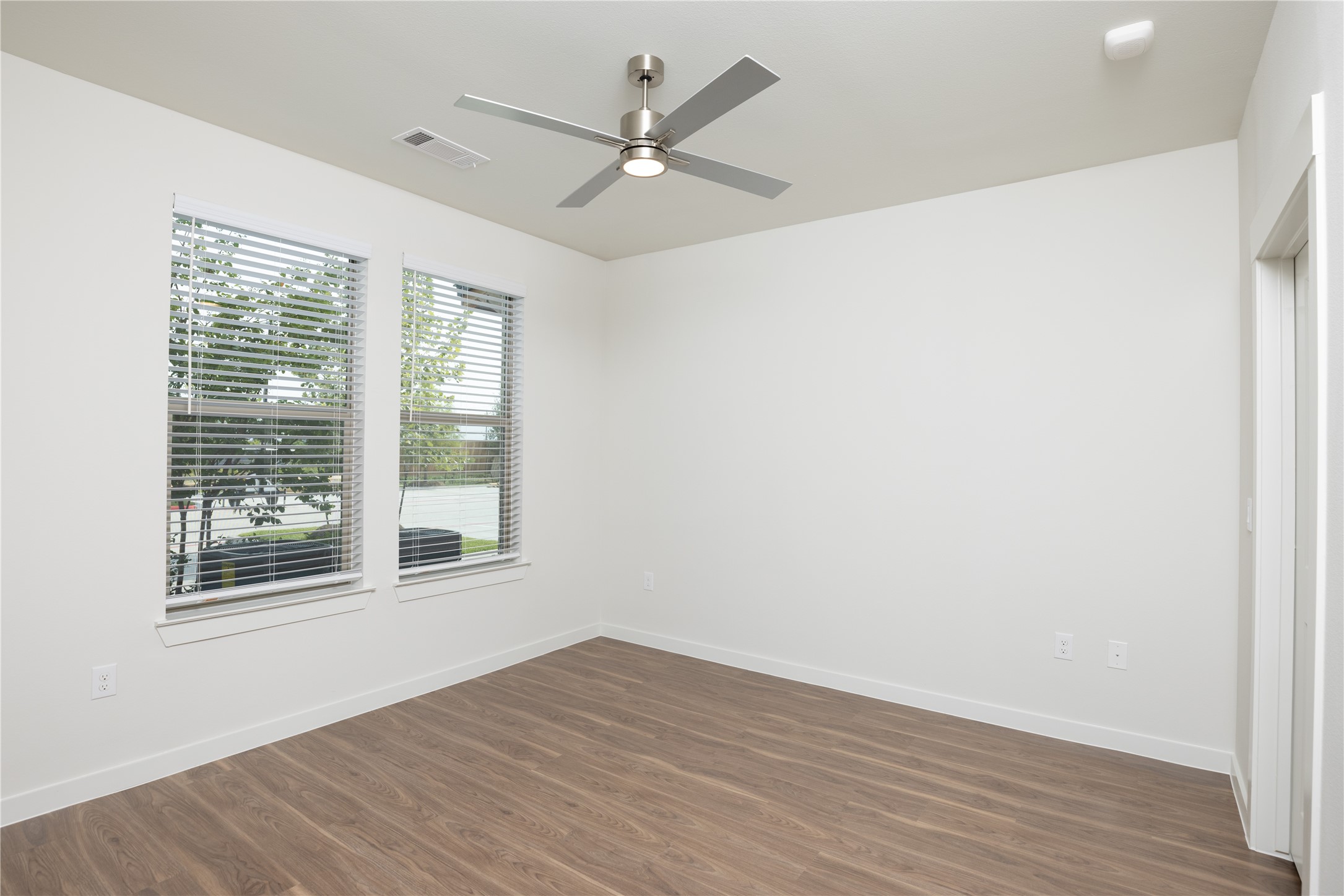 9302 Fry Road, Unit B11034 Cypress, TX 77433 - Photo 5 of 12 an empty room with wooden floor and windows