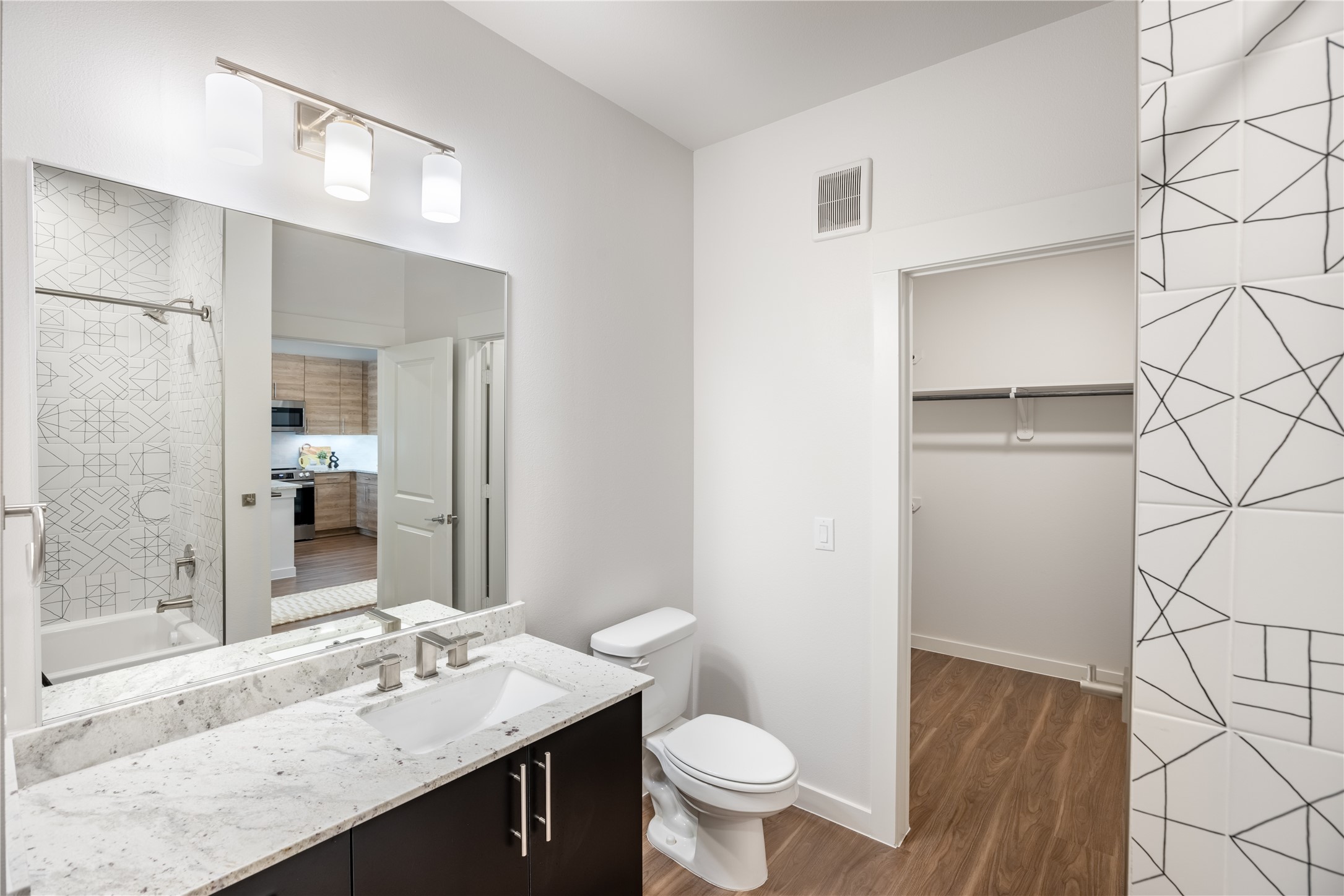 9302 Fry Road, Unit B11034 Cypress, TX 77433 - Photo 6 of 12 a bathroom with a granite countertop sink toilet and shower