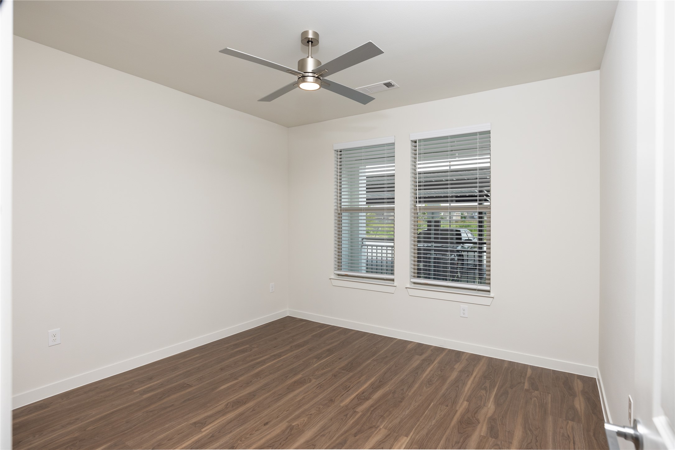 9302 Fry Road, Unit B11034 Cypress, TX 77433 - Photo 8 of 12 an empty room with wooden floor fan and windows